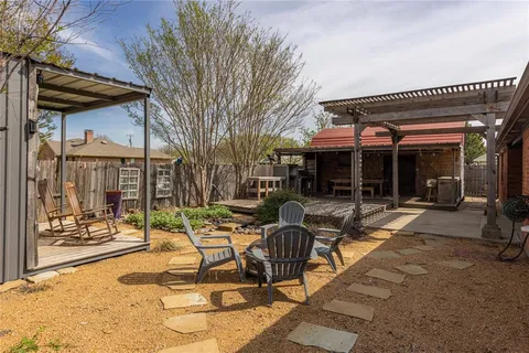 a view of a house with sitting area and garden