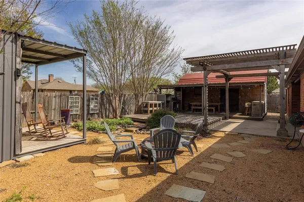 a view of a house with sitting area and garden