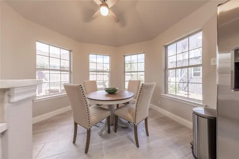 a view of a dining room with furniture and a window