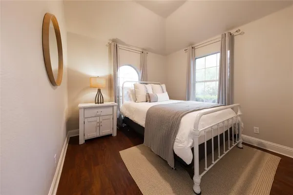 a bedroom with bed and a window