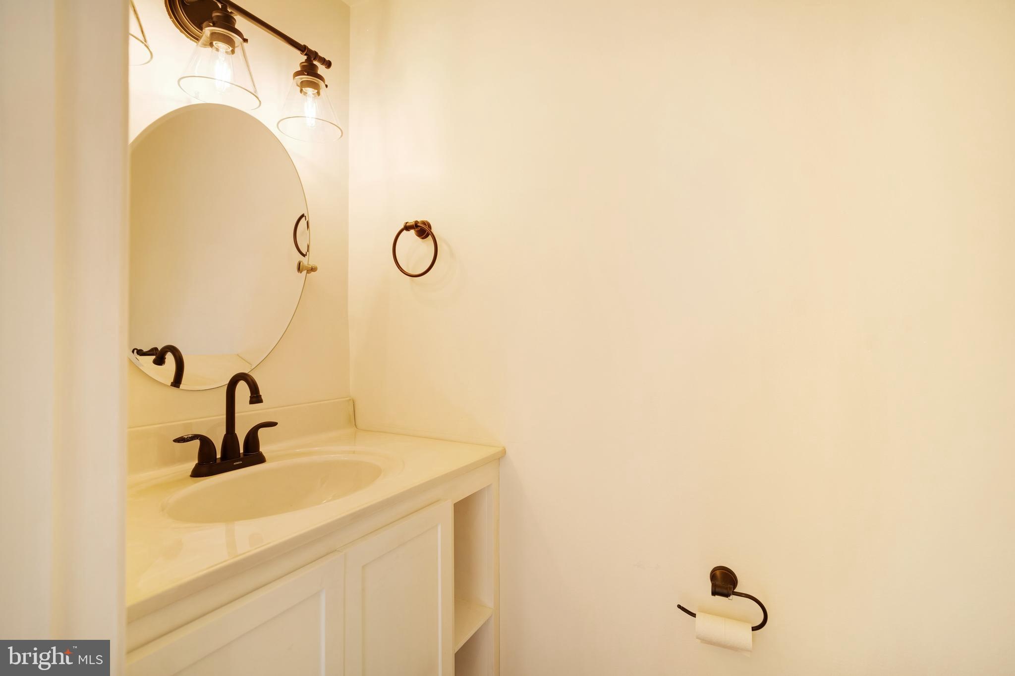 9448 Trevino Terrace, Unit 96 Laurel, MD 20708 - Photo 11 of 38 a bathroom with a sink and mirror