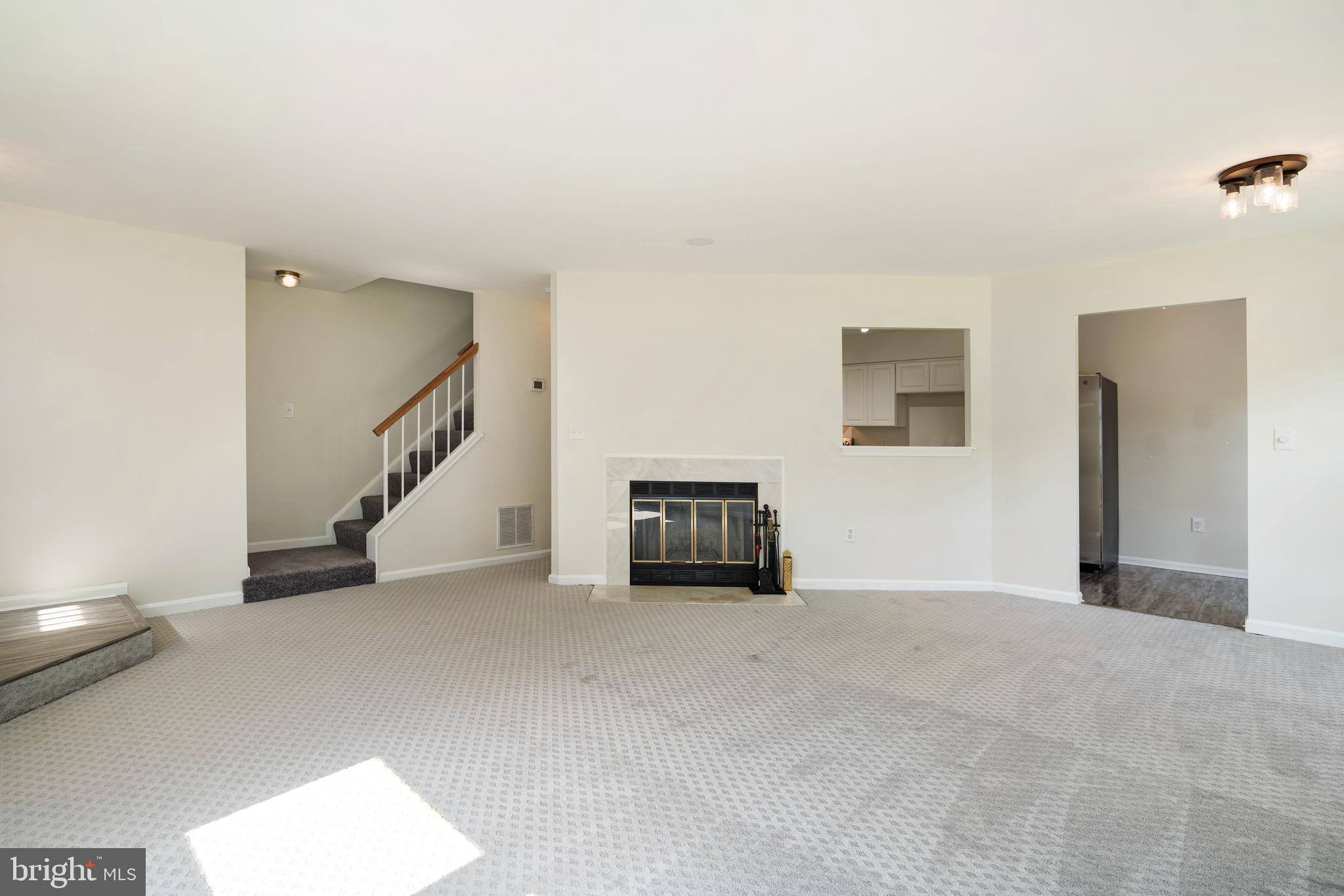 9448 Trevino Terrace, Unit 96 Laurel, MD 20708 - Photo 12 of 38 a view of an empty room with a fireplace