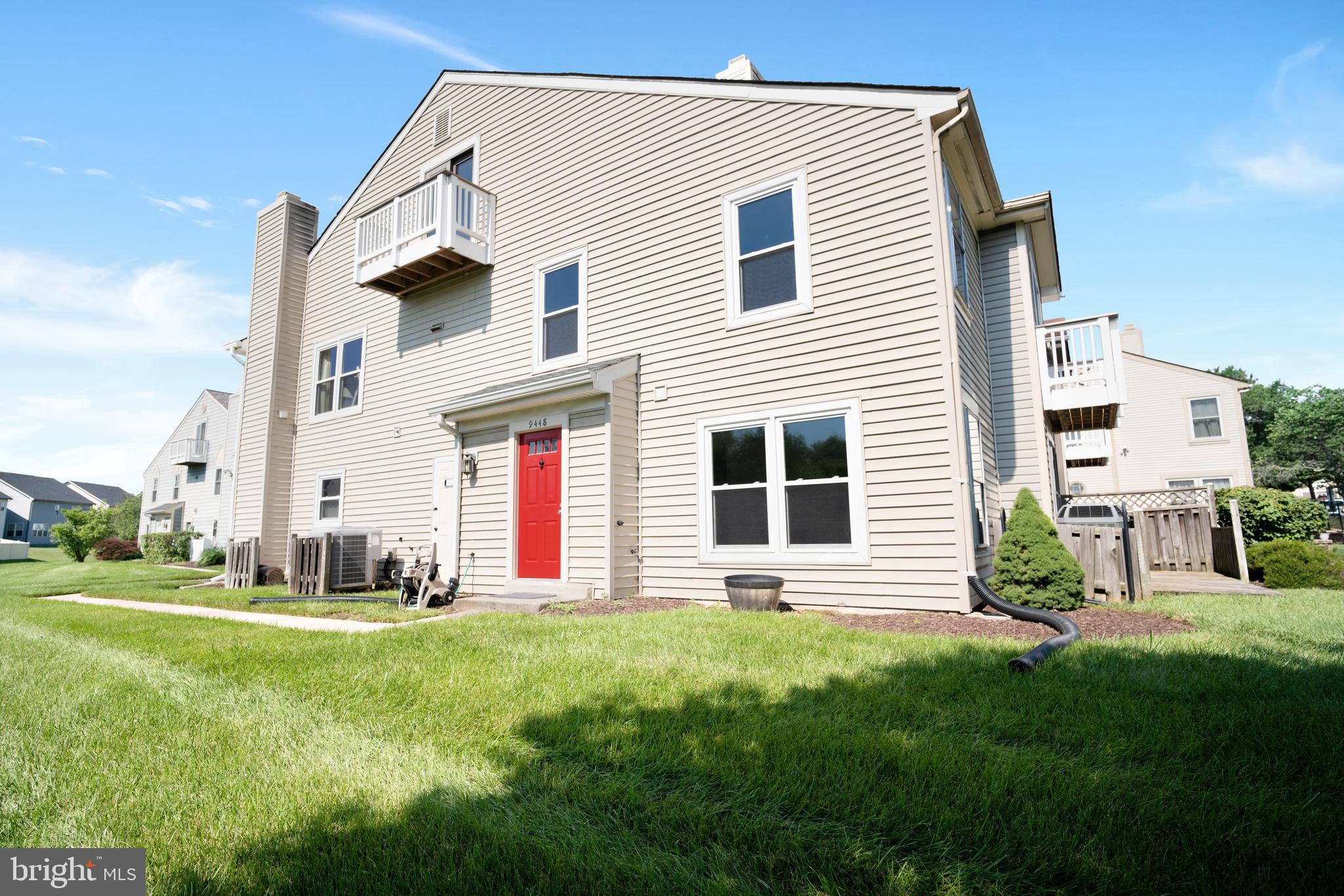 9448 Trevino Terrace, Unit 96 Laurel, MD 20708 - Photo 2 of 38 a front view of house with yard and green space