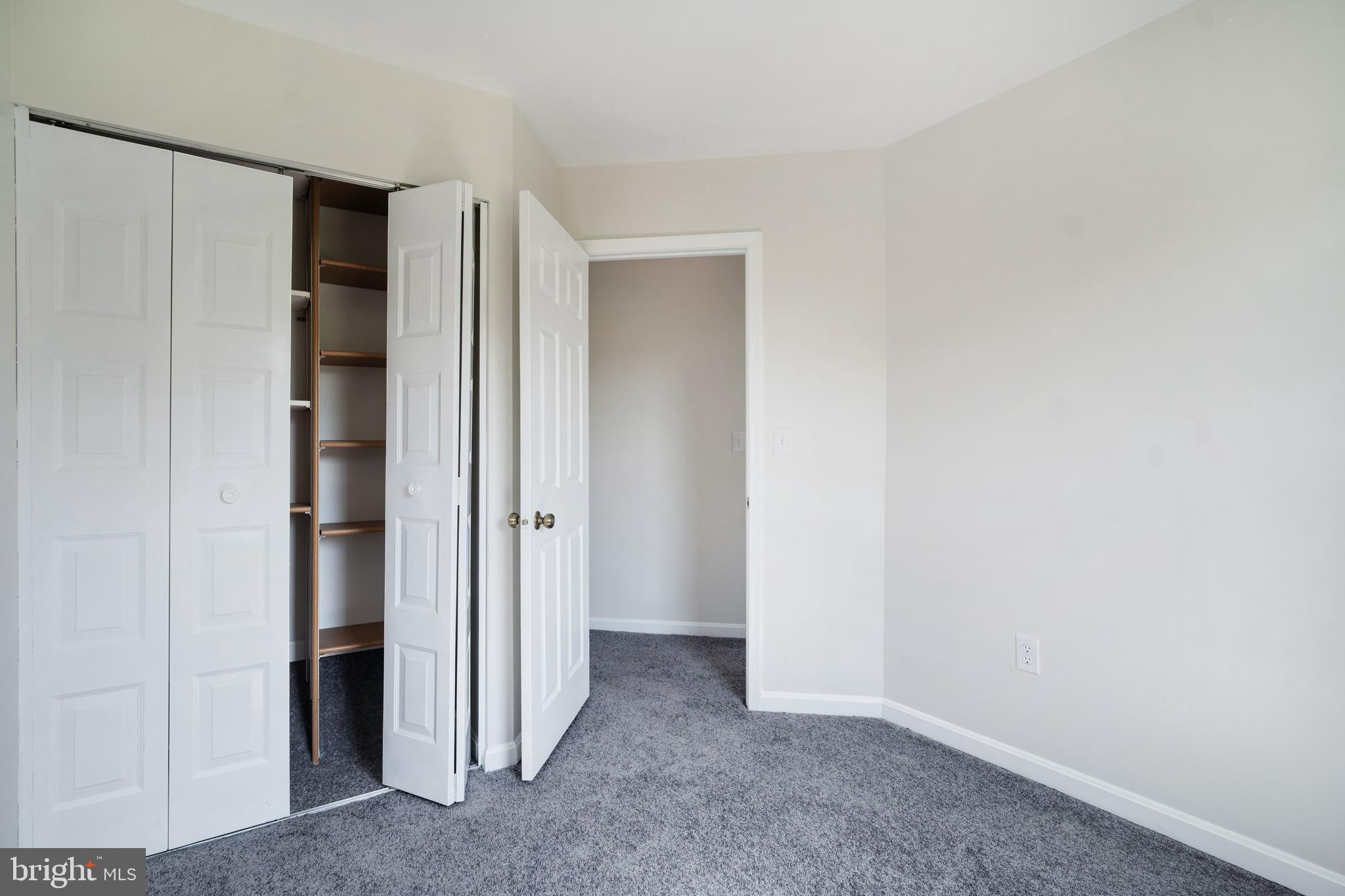 9448 Trevino Terrace, Unit 96 Laurel, MD 20708 - Photo 22 of 38 a view of an empty room with closet and wooden floor
