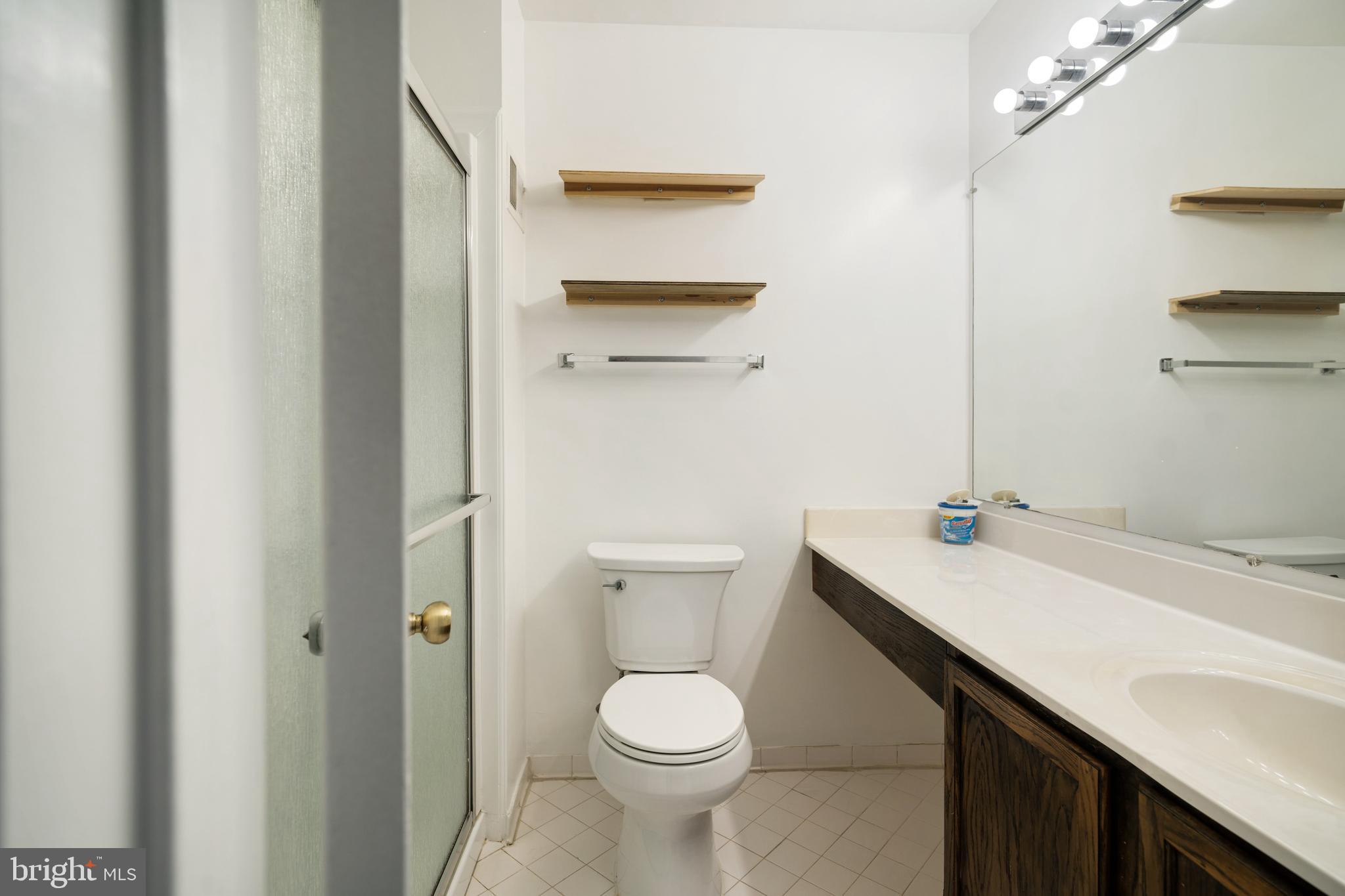 9448 Trevino Terrace, Unit 96 Laurel, MD 20708 - Photo 27 of 38 a bathroom with a sink a toilet and shower