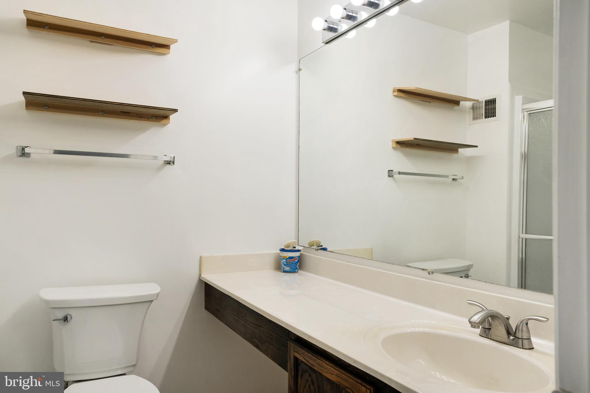 9448 Trevino Terrace, Unit 96 Laurel, MD 20708 - Photo 28 of 38 a bathroom with a sink vanity and toilet