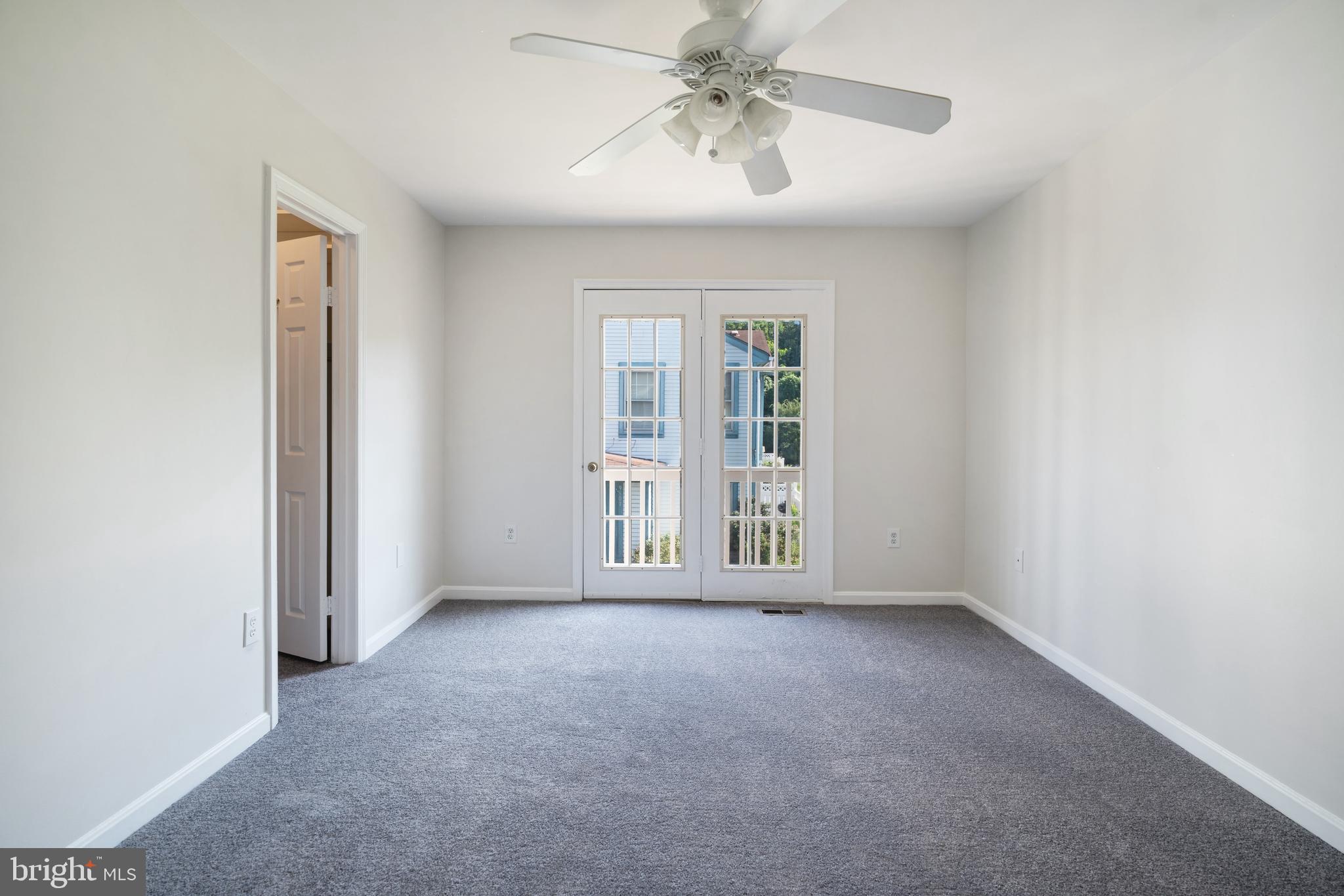 9448 Trevino Terrace, Unit 96 Laurel, MD 20708 - Photo 30 of 38 an empty room with windows and fan