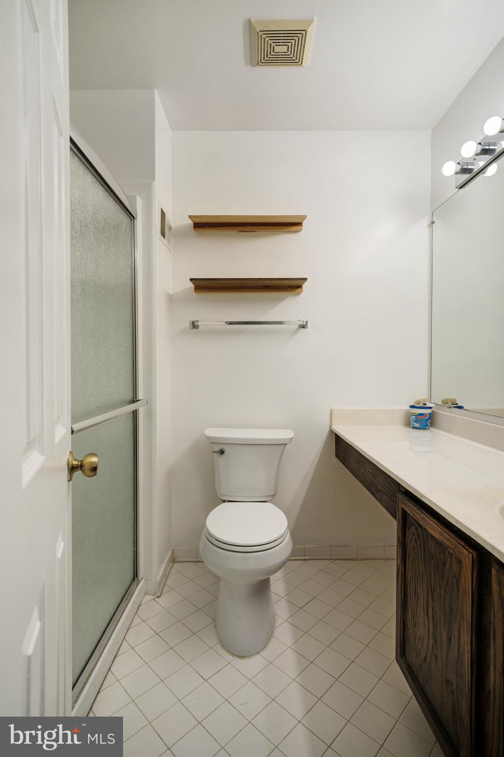 9448 Trevino Terrace, Unit 96 Laurel, MD 20708 - Photo 32 of 38 a bathroom with a toilet a sink and a shower