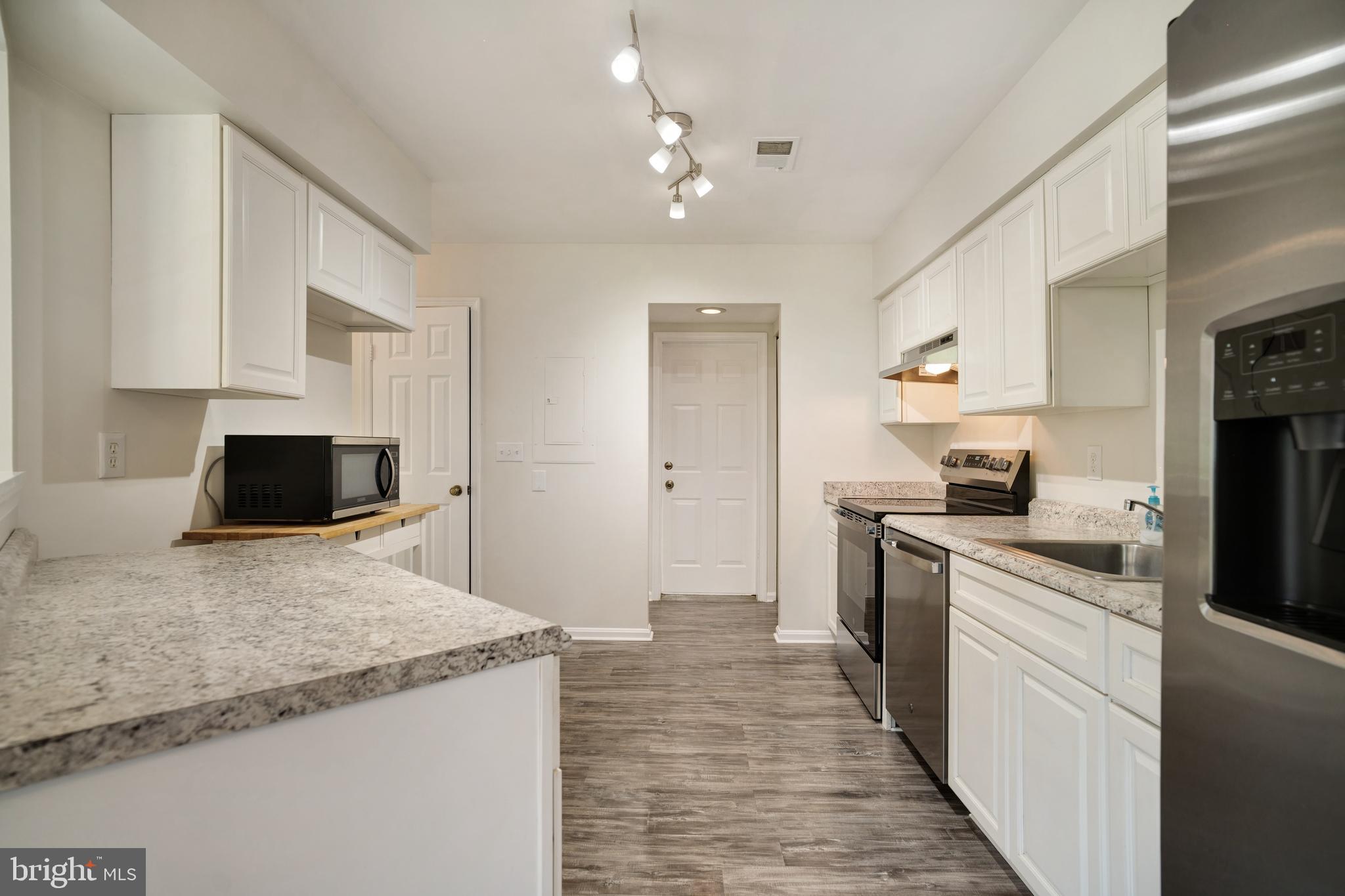 9448 Trevino Terrace, Unit 96 Laurel, MD 20708 - Photo 5 of 38 a kitchen with a sink stove and refrigerator