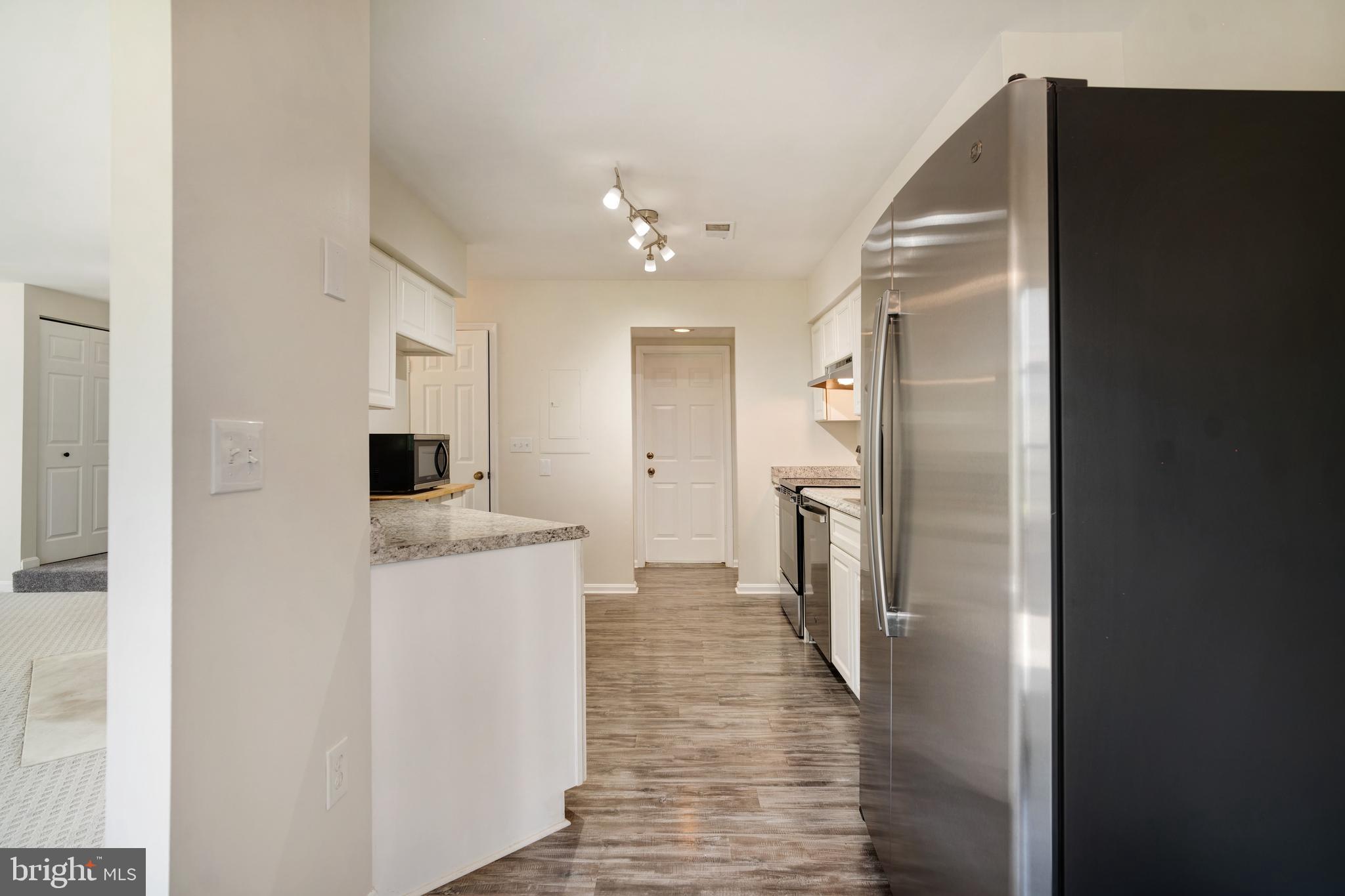 9448 Trevino Terrace, Unit 96 Laurel, MD 20708 - Photo 6 of 38 a kitchen with stainless steel appliances granite countertop a refrigerator and a stove