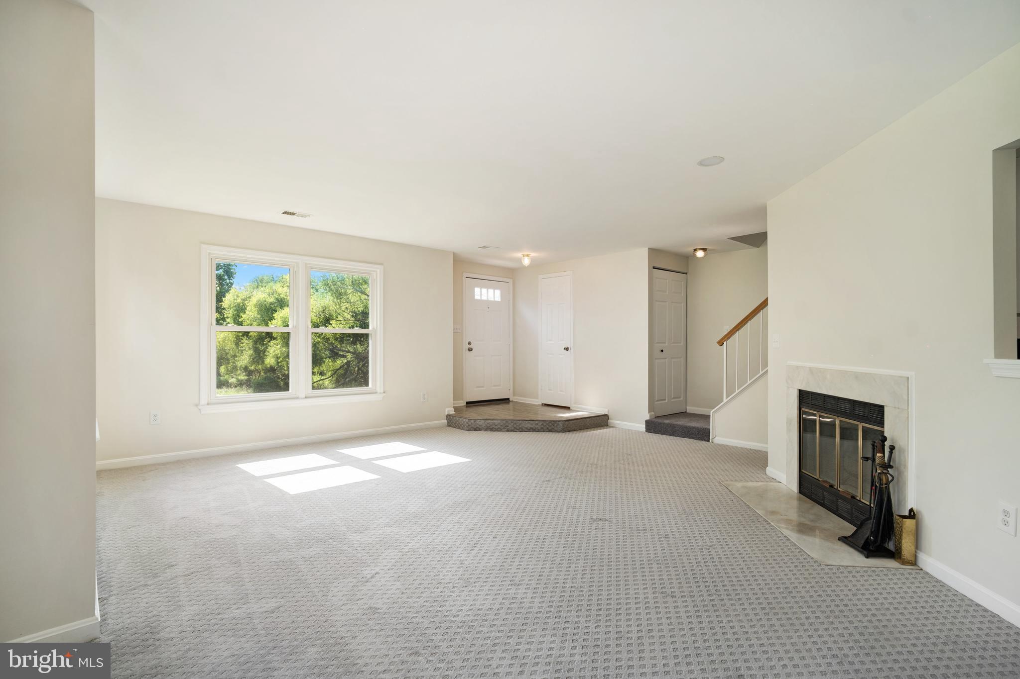 9448 Trevino Terrace, Unit 96 Laurel, MD 20708 - Photo 10 of 38 an empty room with windows and fireplace