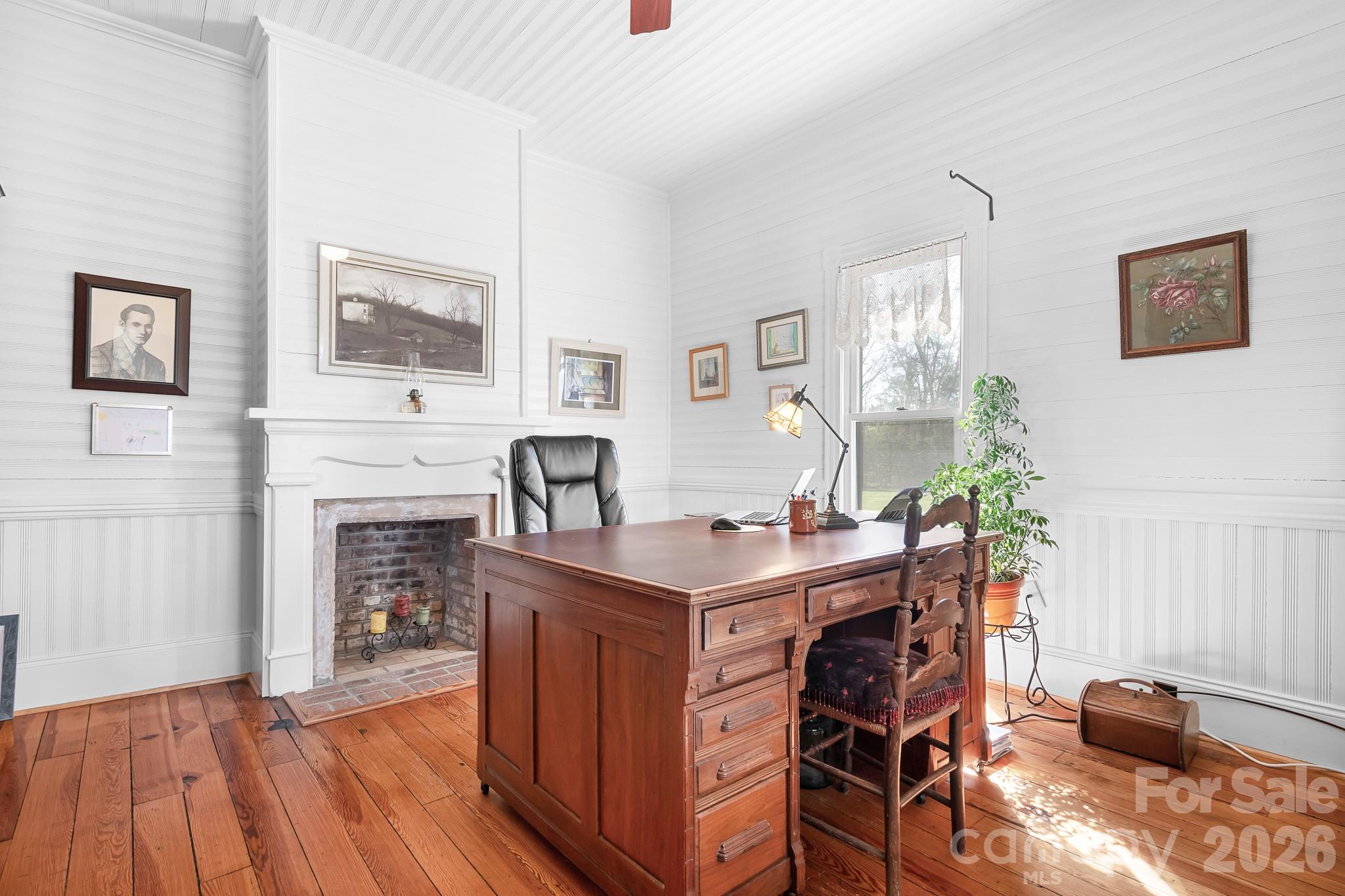 1315 Scotts Creek Road Statesville, NC 28625 - Photo 12 of 30 a view of a workspace with furniture and a fireplace