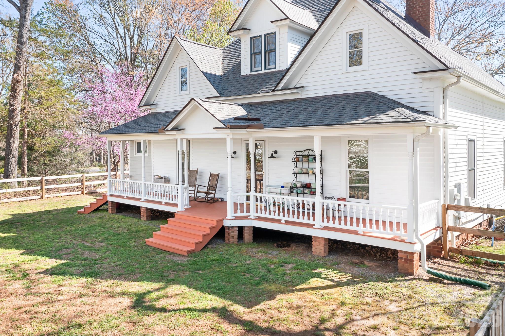 1315 Scotts Creek Road Statesville, NC 28625 - Photo 20 of 30 a front view of a house with a yard table and chairs