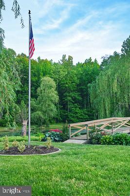 7017 Morris Road Spotsylvania, VA 22551 - Photo 13 of 23 a street view with a garden and trees