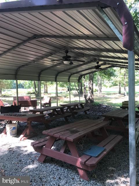 7017 Morris Road Spotsylvania, VA 22551 - Photo 21 of 23 a view of a backyard with table and chairs under an umbrella