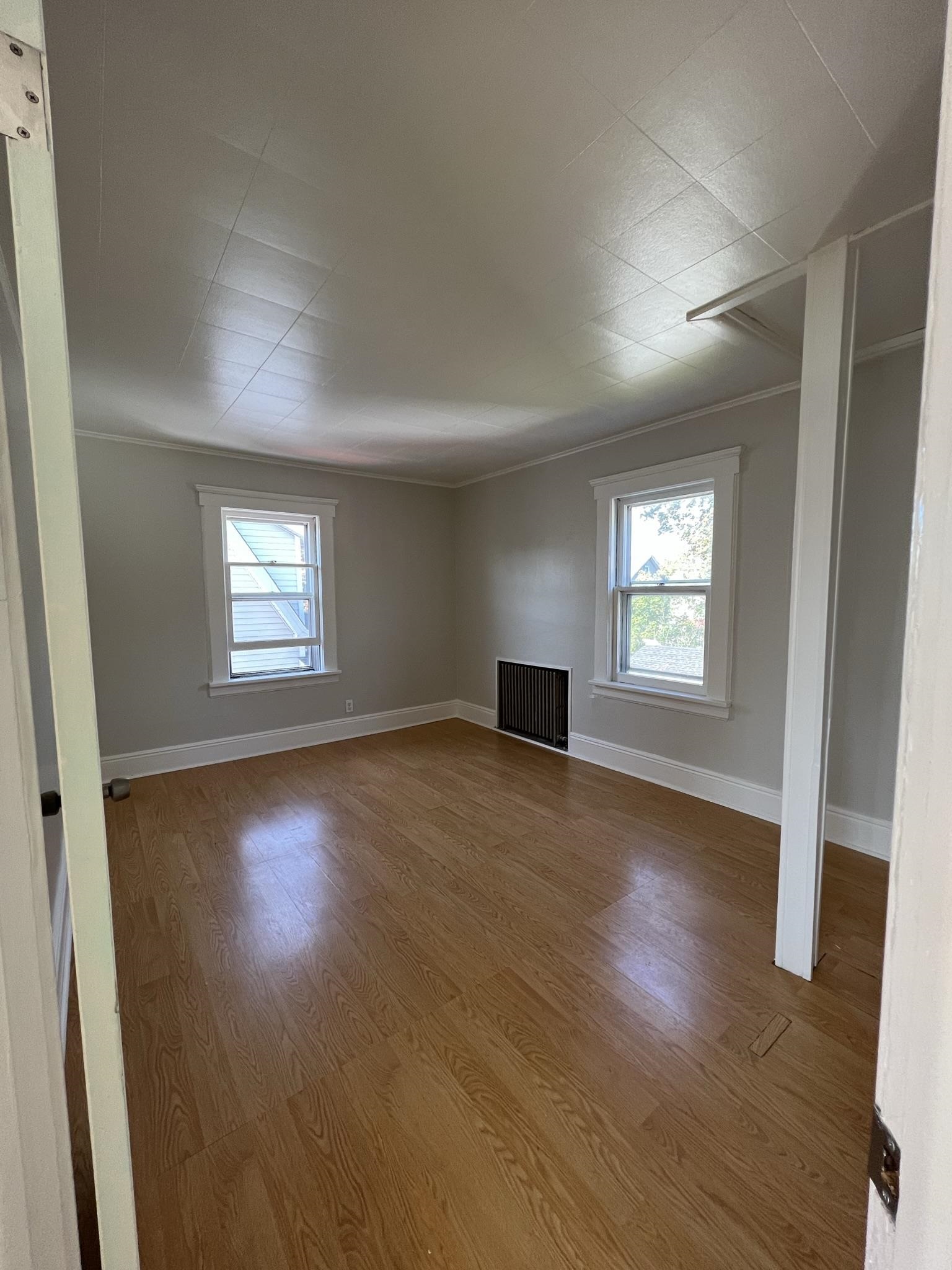 128 Hazelton Street, Unit 2 Ridgefield Park, NJ 07660 - Photo 3 of 6 an empty room with wooden floor and windows