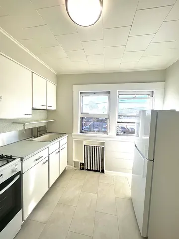 a kitchen with a refrigerator and a sink