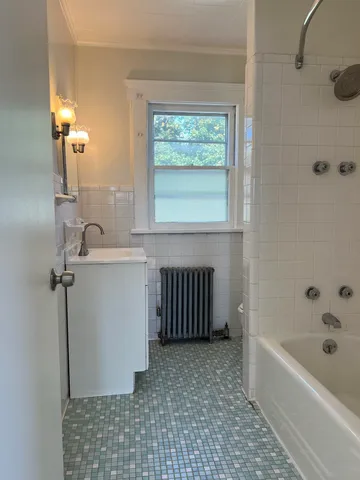 a bathroom with a bathtub and window