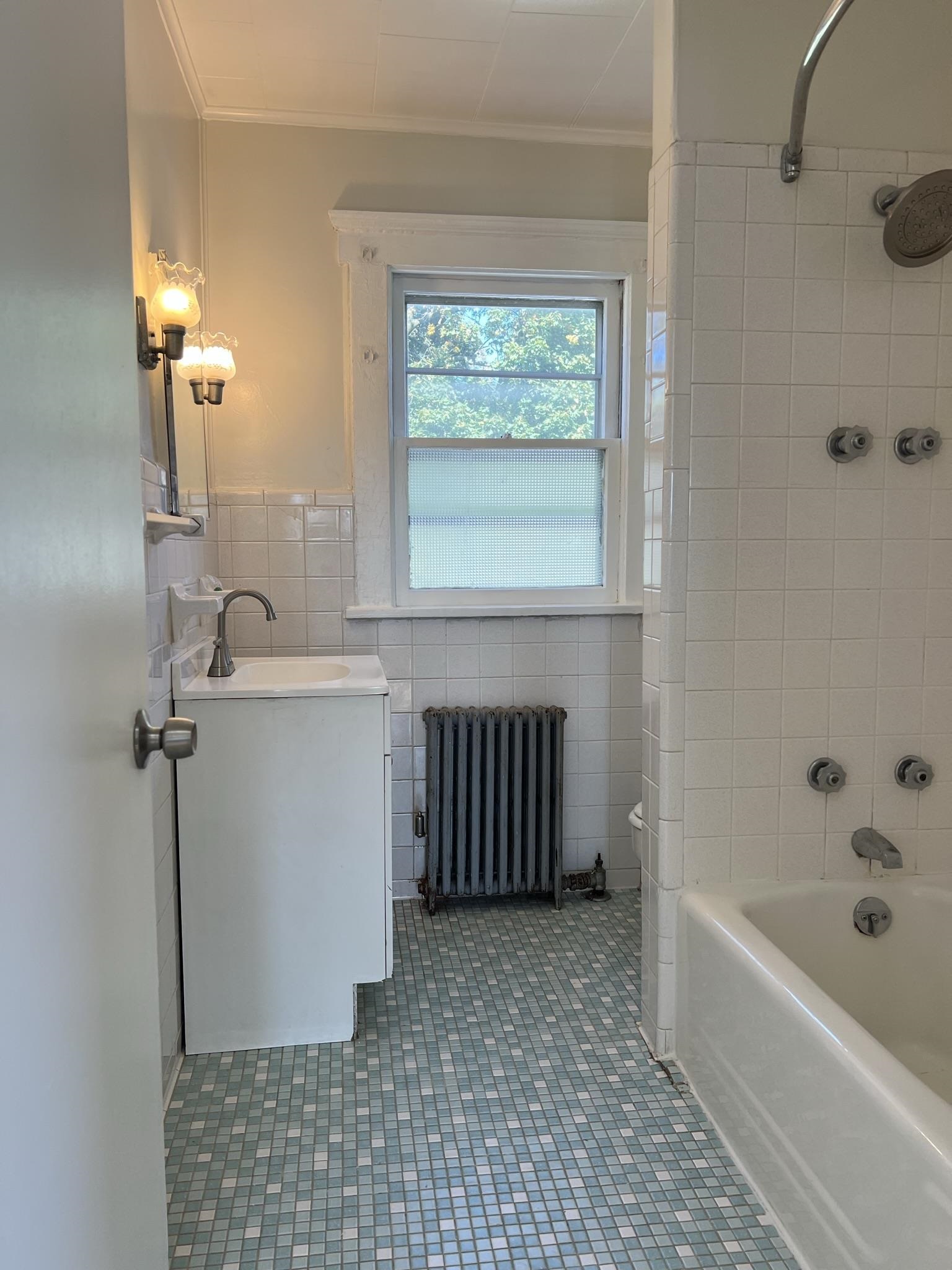 128 Hazelton Street, Unit 2 Ridgefield Park, NJ 07660 - Photo 6 of 6 a bathroom with a bathtub and window