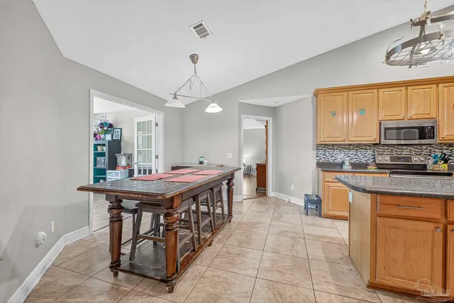 a bed room with a bed a television and a couch