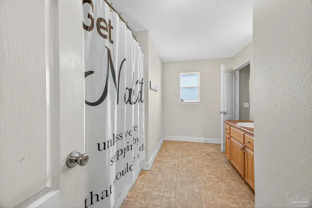 a bedroom with natural light and a bed