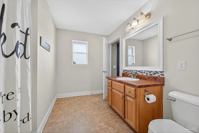a en suite bathroom with a sink and a mirror