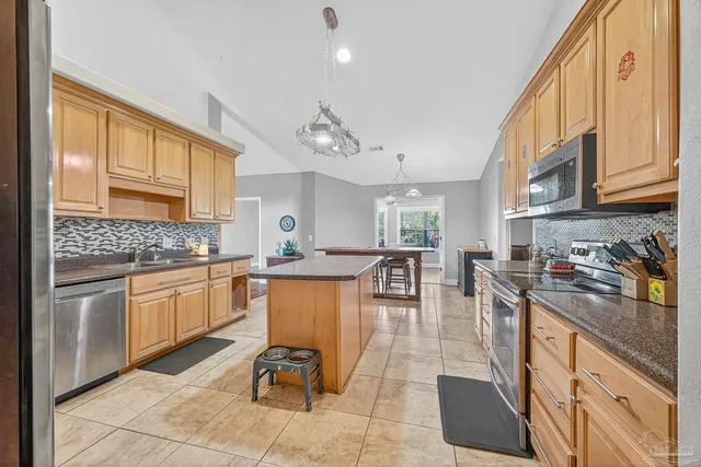 a kitchen with granite countertop appliances cabinets and furniture