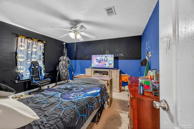 a view of a hallway with a livingroom and a bathroom