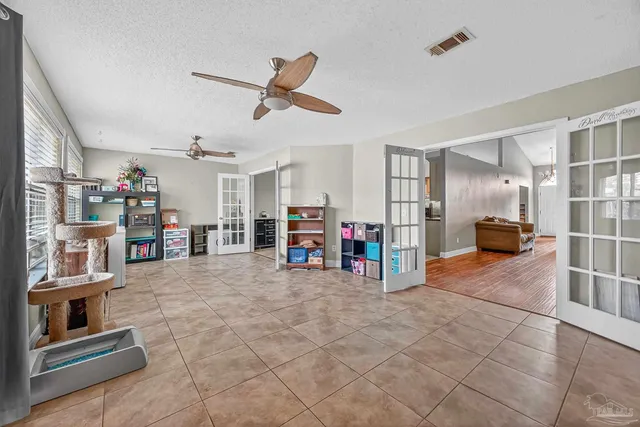 a view of a livingroom with furniture and a ceiling fan