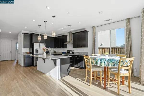 a kitchen with stainless steel appliances kitchen island granite countertop a sink and cabinets