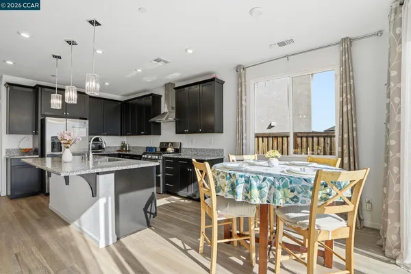 a large kitchen with a table and chairs in it