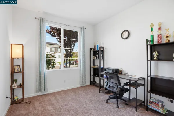 a view of a workspace with furniture and a window