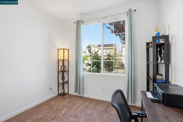 a view of a bedroom with a window and bathroom