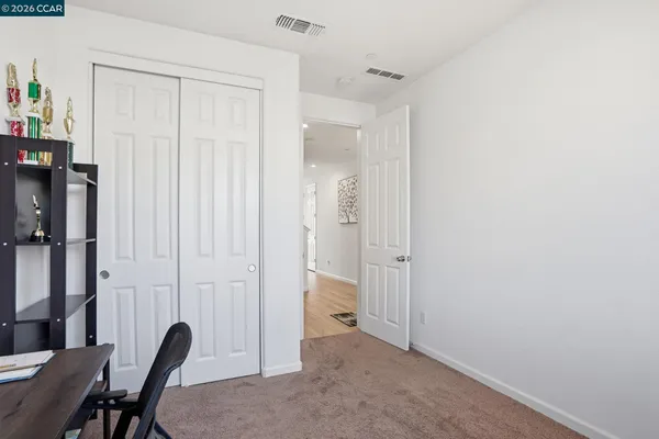 a view of a workspace with furniture and a window