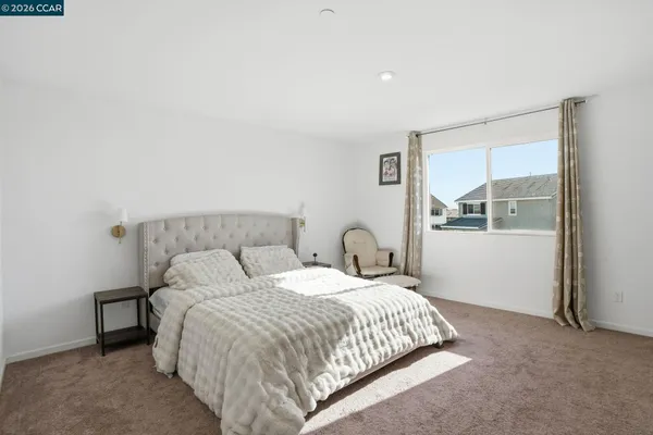 a bedroom with a bed and window