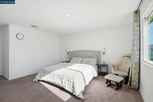 a bedroom with a bed and chair