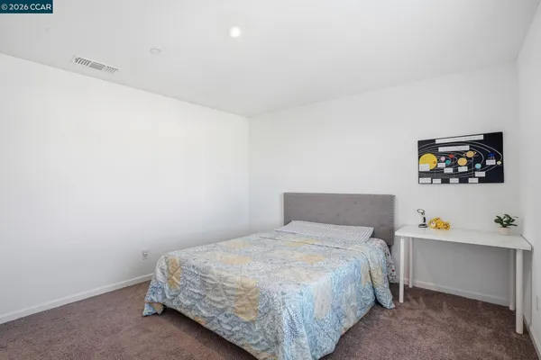 a bedroom with a bed and wall paintings