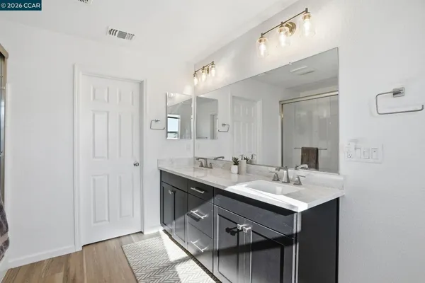 a bathroom with a sink double vanity and a mirror