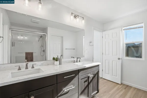 a bathroom with a double vanity sink mirror and