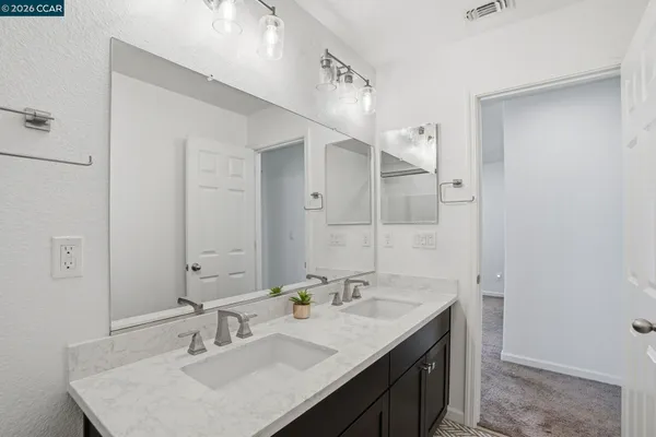 a bathroom with a sink double vanity and a mirror