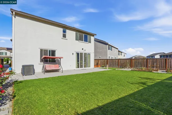 a view of a house with a yard and sitting area