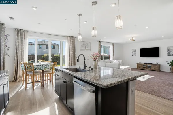 a kitchen with granite countertop a sink and a stove