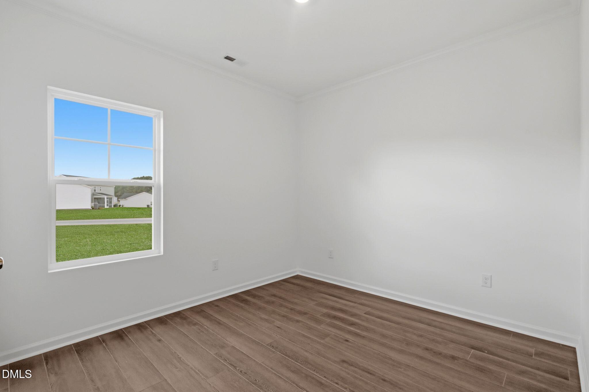 155 Digging Time Avenue Princeton, NC 27569 - Photo 19 of 29 a view of a room with wooden floor and a window