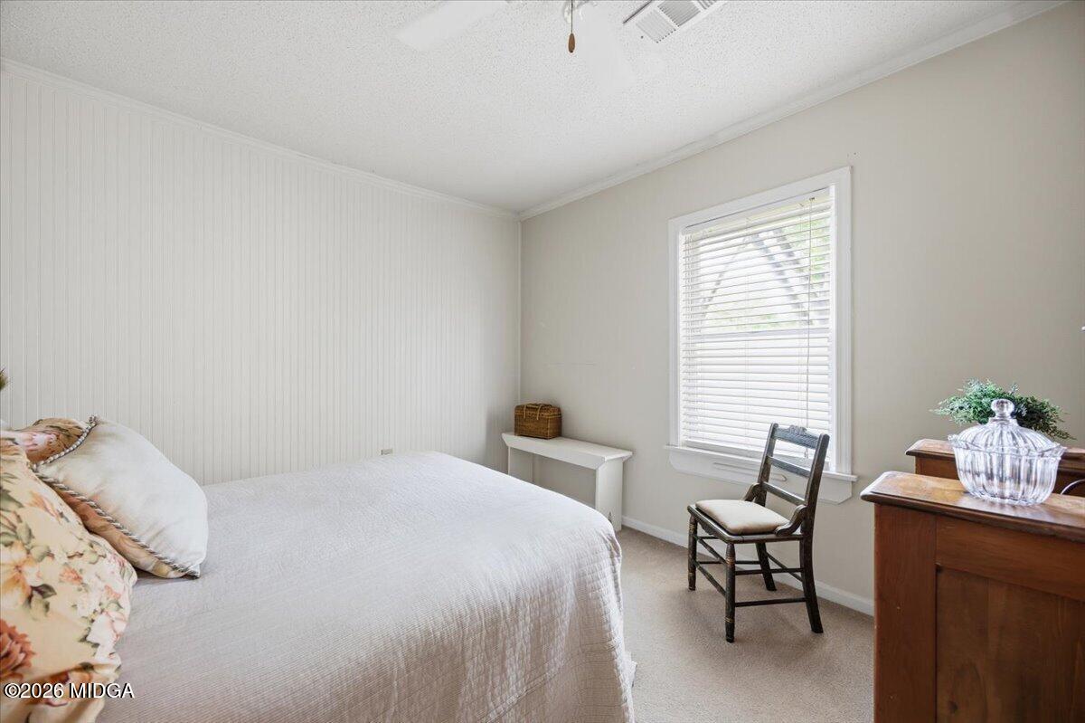 214 Howard Roberts Road Gray, GA 31032 - Photo 22 of 36 a bedroom with a bed and a window