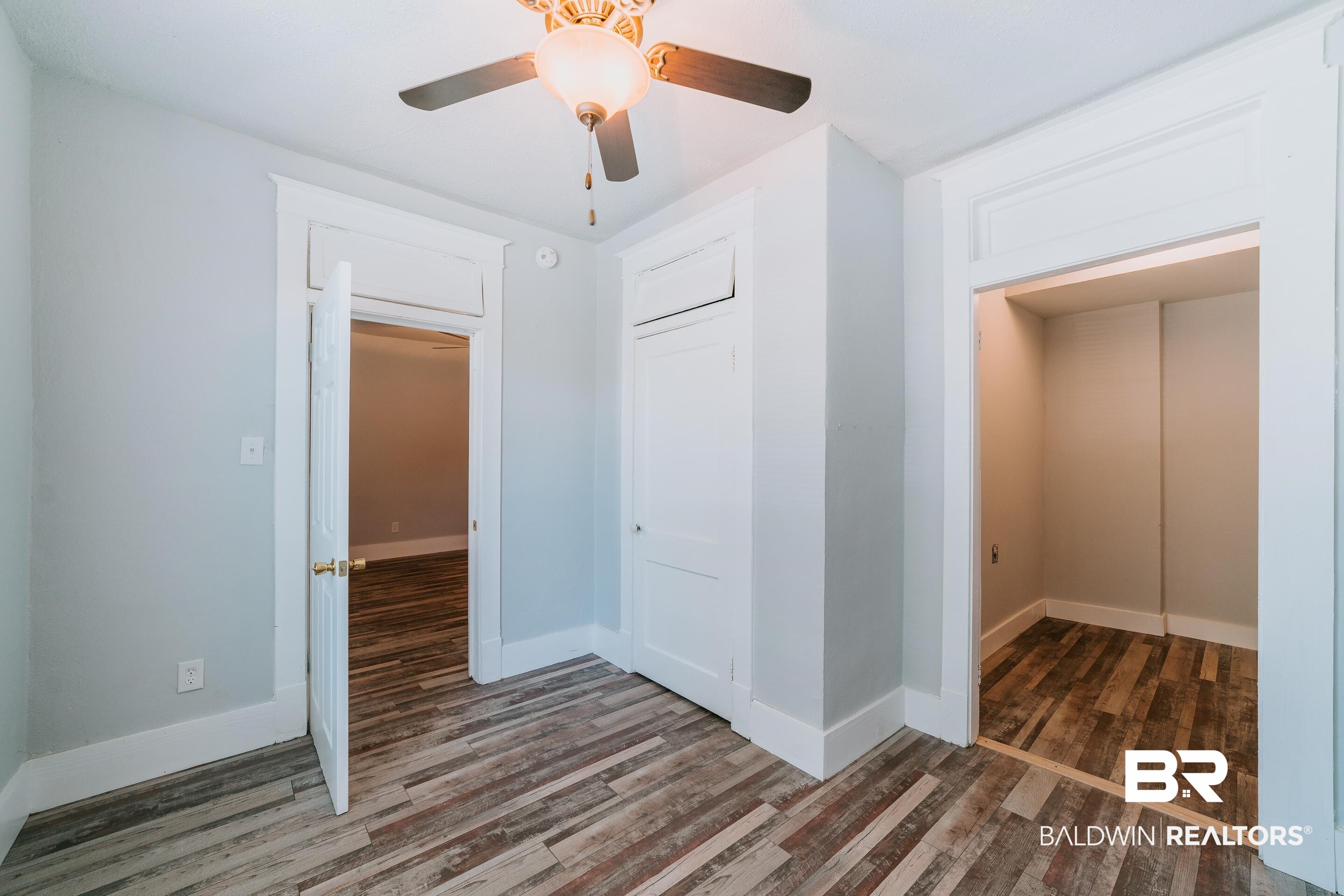 5 North Fulton Street Mobile, AL 36607 - Photo 5 of 55 Unfurnished bedroom with ceiling fan, dark wood-type flooring, and a closet