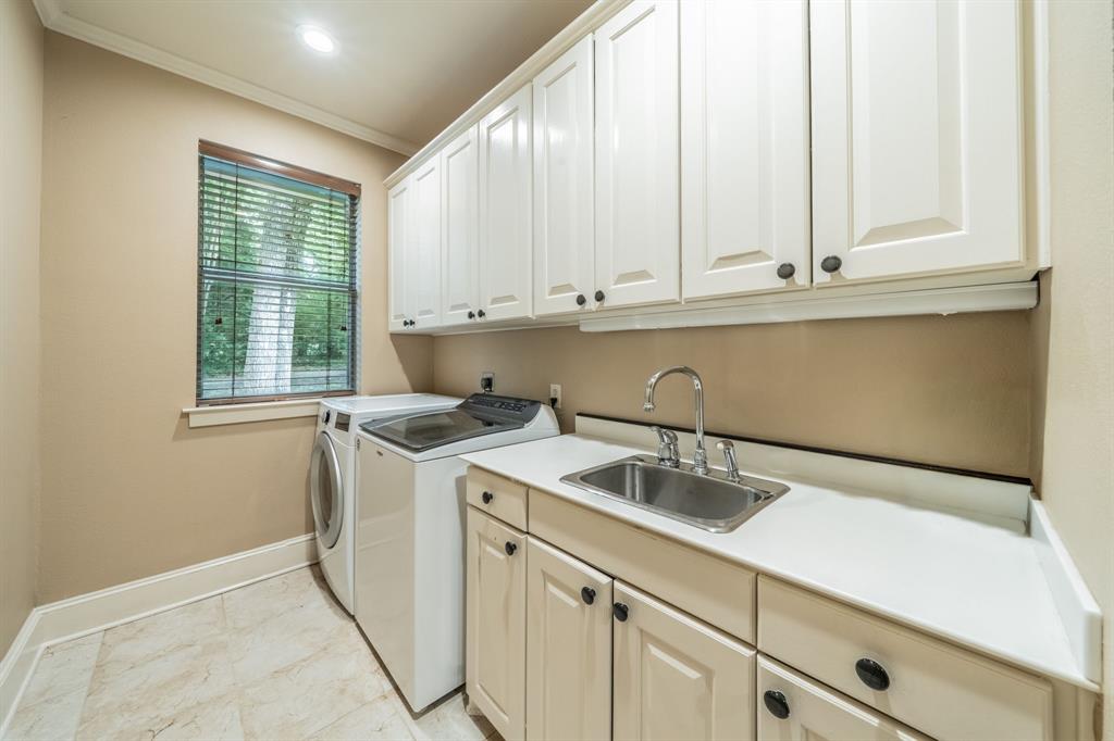 7451 County Road 1509 Athens, TX 75751 - Photo 21 of 36 a kitchen with granite countertop white cabinets and a sink