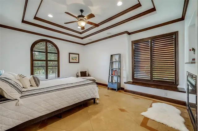 a bedroom with a large bed and a large window