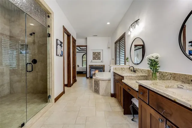a spacious bathroom with a double vanity sink mirror and shower