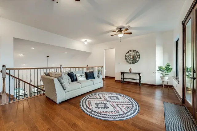 a living room with furniture and a wooden floor