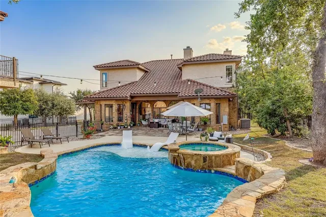 a view of a house with swimming pool and sitting area